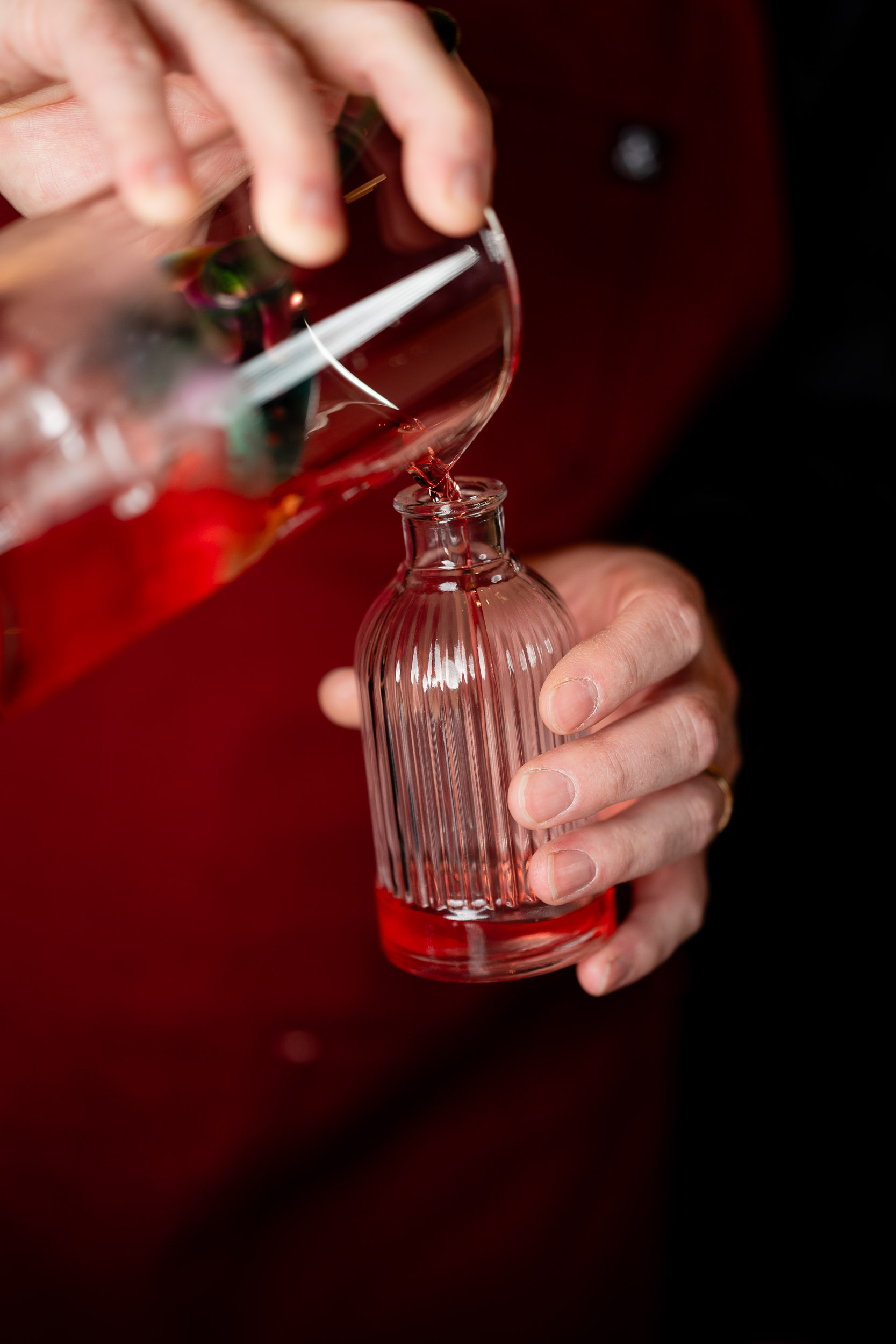 red cocktail being poured